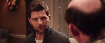 Movie still from “Krampus” (2015), directed by Michael Dougherty – A person looking at a mirror; Close Up shot, Over the shoulder angle