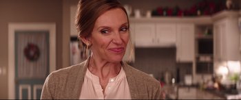 Movie still from “Krampus” (2015), directed by Michael Dougherty – A person wearing a jacket in a room; Close Up shot, Over the shoulder angle