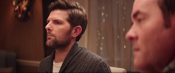 Movie still from “Krampus” (2015), directed by Michael Dougherty – A person sitting in a chair; Close Up shot, Over the shoulder angle