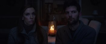 Movie still from “Krampus” (2015), directed by Michael Dougherty – A man and a woman sitting in front of a candle; Medium shot, Over the shoulder angle