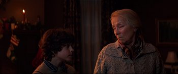 Movie still from “Krampus” (2015), directed by Michael Dougherty – A woman and a young boy standing next to each other in a room; Close Up shot, Over the shoulder angle