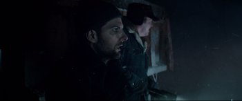 Movie still from “Krampus” (2015), directed by Michael Dougherty – Two men are standing next to each other in the dark; Close Up shot, Low angle