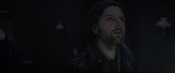 Movie still from “Krampus” (2015), directed by Michael Dougherty – A man with a beard wearing a black jacket; Close Up shot, Low angle