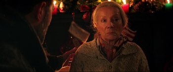 Movie still from “Krampus” (2015), directed by Michael Dougherty – An old woman with a knife in her mouth; Close Up shot, Over the shoulder angle