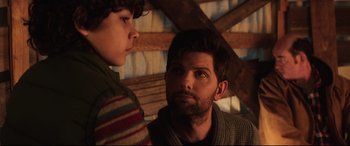 Movie still from “Krampus” (2015), directed by Michael Dougherty – A man and a boy are looking at each other; Close Up shot, Over the shoulder angle