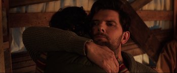 Movie still from “Krampus” (2015), directed by Michael Dougherty – A man and a woman hugging each other in the dark; Close Up shot, Over the shoulder angle