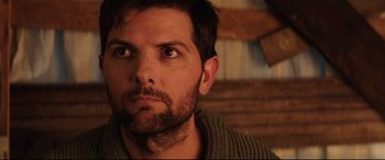 Movie still from “Krampus” (2015), directed by Michael Dougherty – A person with a beard looking at the camera; Close Up shot, Over the shoulder angle