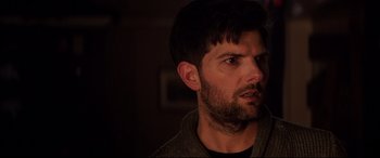 Movie still from “Krampus” (2015), directed by Michael Dougherty – A person with a beard looking to his left; Close Up shot, Over the shoulder angle