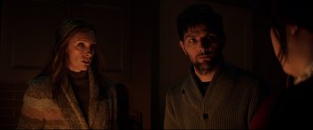 Movie still from “Krampus” (2015), directed by Michael Dougherty – A man and a woman standing next to each other in the dark; Close Up shot, Over the shoulder angle