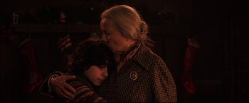 Movie still from “Krampus” (2015), directed by Michael Dougherty – An older woman and a young boy embracing each other; Close Up shot, Over the shoulder angle
