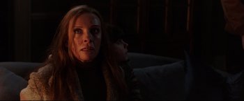 Movie still from “Krampus” (2015), directed by Michael Dougherty – A woman and a little girl sitting on a couch in a dark room; Close Up shot, Low angle