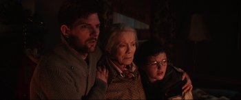 Movie still from “Krampus” (2015), directed by Michael Dougherty – A man , woman , and a boy standing next to each other; Close Up shot, Over the shoulder angle