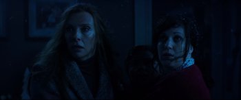 Movie still from “Krampus” (2015), directed by Michael Dougherty – Two women are standing in a dark room; Close Up shot, Low angle