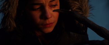 Movie still from “Krampus” (2015), directed by Michael Dougherty – A person with a bird on their shoulder crying; Extreme Close Up shot, Low angle