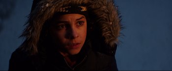 Movie still from “Krampus” (2015), directed by Michael Dougherty – A person wearing a jacket with a fur hood; Close Up shot, Low angle