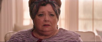 Movie still from “Krampus” (2015), directed by Michael Dougherty – An older woman wearing a head scarf and earrings; Close Up shot, Low angle