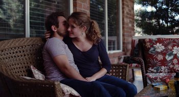 Movie still from “Krisha” (2015), directed by Trey Edward Shults – A man and a woman are sitting on a porch; Medium shot, Over the shoulder angle