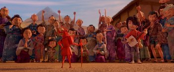 Movie still from “Kubo and the Two Strings” (2016), directed by Travis Knight – A group of people standing in front of an animated character; Wide shot, High angle