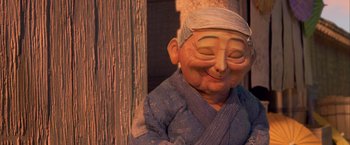 Movie still from “Kubo and the Two Strings” (2016), directed by Travis Knight – A statue of a person smiling; Close Up shot, Low angle