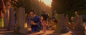 Movie still from “Kubo and the Two Strings” (2016), directed by Travis Knight – An animated scene of a man kneeling in front of a child; Wide shot, Low angle