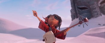 Movie still from “Kubo and the Two Strings” (2016), directed by Travis Knight – An animated character is holding a guitar and singing; Medium shot, Low angle