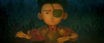 Movie still from “Kubo and the Two Strings” (2016), directed by Travis Knight – A character's face with a green leaf on it's eye; Close Up shot, Over the shoulder angle