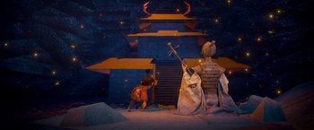 Movie still from “Kubo and the Two Strings” (2016), directed by Travis Knight – A scene of a stage show with a man and a woman; Wide shot, High angle