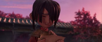 Movie still from “Kubo and the Two Strings” (2016), directed by Travis Knight – A young boy holding a piece of paper in his hands; Close Up shot, Low angle