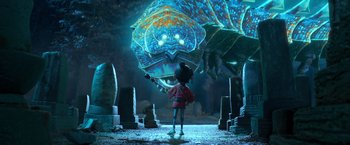 Movie still from “Kubo and the Two Strings” (2016), directed by Travis Knight – A person standing in front of a giant lizard; Extreme Wide shot, Low angle