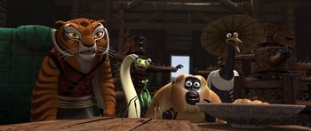 Movie still from “Kung Fu Panda 2” (2011), directed by Jennifer Yuh Nelson – A group of cartoon characters sitting on top of a wooden table; Wide shot, Low angle