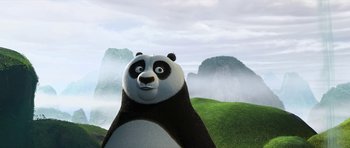 Movie still from “Kung Fu Panda 2” (2011), directed by Jennifer Yuh Nelson – A panda bear standing on top of a green hill; Close Up shot, Low angle