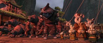 Movie still from “Kung Fu Panda 2” (2011), directed by Jennifer Yuh Nelson – A group of people standing next to each other on a dirt ground; Wide shot, Low angle