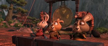Movie still from “Kung Fu Panda 2” (2011), directed by Jennifer Yuh Nelson – A group of cartoon characters playing a musical instrument; Wide shot, Low angle