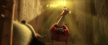 Movie still from “Kung Fu Panda 2” (2011), directed by Jennifer Yuh Nelson – An animated bird sitting on a chair in a room; Medium shot, Low angle