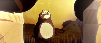 Movie still from “Kung Fu Panda 2” (2011), directed by Jennifer Yuh Nelson – A cartoon of a panda bear standing in the grass; Medium shot, Low angle