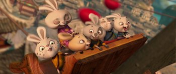 Movie still from “Kung Fu Panda 2” (2011), directed by Jennifer Yuh Nelson – A group of cartoon rabbits are sitting on a ledge; Wide shot, High angle