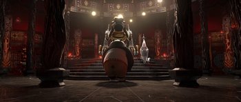 Movie still from “Kung Fu Panda 2” (2011), directed by Jennifer Yuh Nelson – An image of a person sitting on top of an animal statue; Wide shot, Low angle