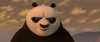 Movie still from “Kung Fu Panda 2” (2011), directed by Jennifer Yuh Nelson – An animated panda bear with green eyes and black fur; Close Up shot, Low angle