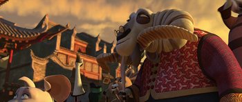 Movie still from “Kung Fu Panda 2” (2011), directed by Jennifer Yuh Nelson – An animated sheep holding an umbrella in front of buildings; Medium shot, Low angle