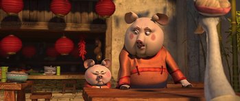 Movie still from “Kung Fu Panda 2” (2011), directed by Jennifer Yuh Nelson – A couple of pigs sitting on top of a table; Medium shot, Low angle