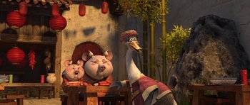 Movie still from “Kung Fu Panda 2” (2011), directed by Jennifer Yuh Nelson – Two pigs and an ostrich are sitting at a table in front of bamboo; Wide shot, High angle