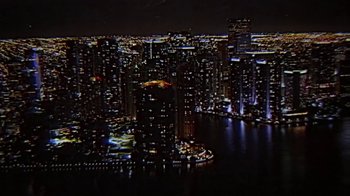 Movie still from “Kung Fury” (2015), directed by David Sandberg – A view of a city at night from a helicopter; Extreme Wide shot, High angle