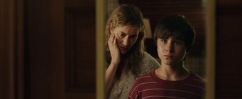 Movie still from “Labor Day” (2013), directed by Jason Reitman – A woman standing next to a boy in a room; Close Up shot, Over the shoulder angle