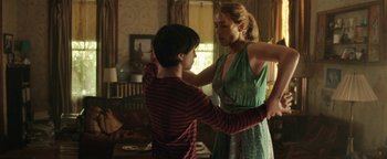 Movie still from “Labor Day” (2013), directed by Jason Reitman – A woman and a young boy in a living room; Medium shot, Over the shoulder angle