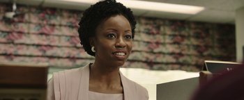 Movie still from “Labor Day” (2013), directed by Jason Reitman – A black woman with short black hair wearing a pink suit; Close Up shot, Low angle