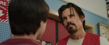 Movie still from “Labor Day” (2013), directed by Jason Reitman – A person with long hair and a beard; Close Up shot, Over the shoulder angle