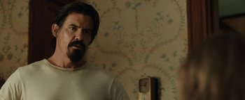 Movie still from “Labor Day” (2013), directed by Jason Reitman – A man standing in front of a wall with a clock on the wall; Close Up shot, Over the shoulder angle