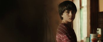 Movie still from “Labor Day” (2013), directed by Jason Reitman – A young man in a striped shirt is posing for a picture; Close Up shot, Low angle