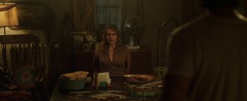 Movie still from “Labor Day” (2013), directed by Jason Reitman – A woman sitting at a dining room table; Medium shot, Over the shoulder angle