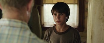 Movie still from “Labor Day” (2013), directed by Jason Reitman – A young boy is looking at a mirror; Close Up shot, Over the shoulder angle